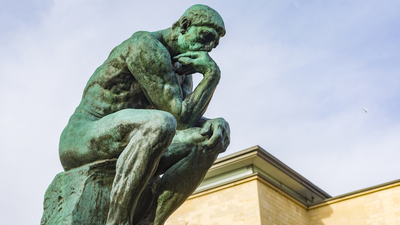 Paris, France - December 5, 2015: August Rodin's famous sculpture The Thinker in the grounds of the Musee Rodin, Paris