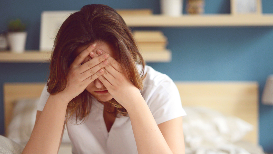 Unhappy girl in a bedroom