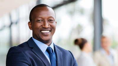 portrait of successful african office worker with arms crossed