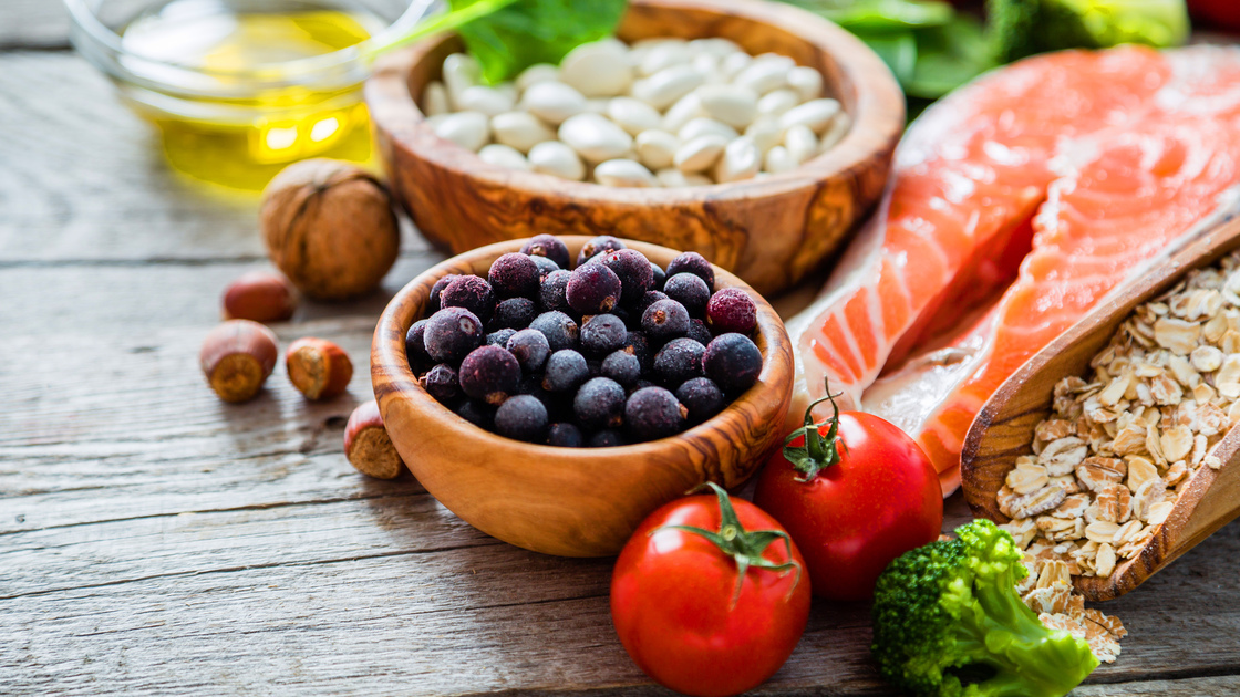 Selection of food that is good for the heart, rustic wood background