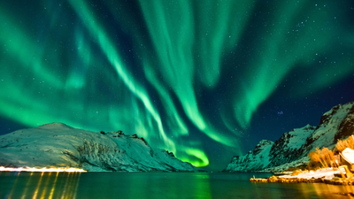 The aurora in front of the Norwegian fjord at Tromso, Norway.
