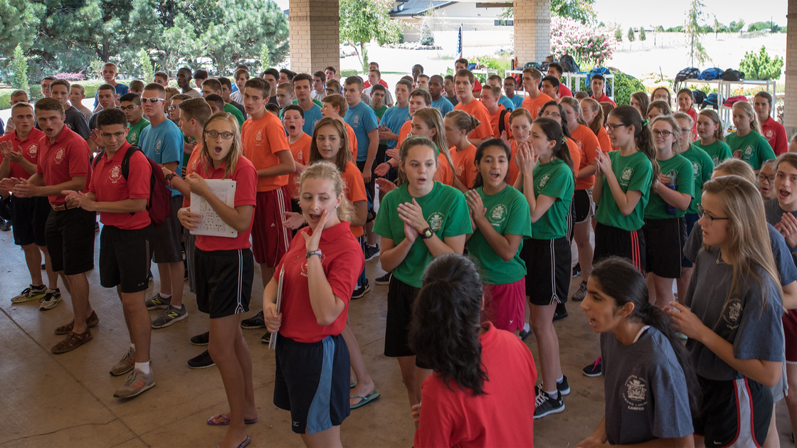 Campers and staff cheer before entering the lunch hall on the first day of PYC 2017.
