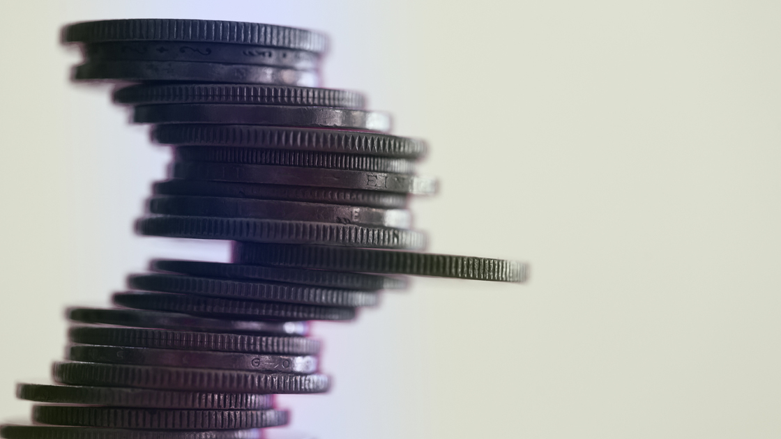 Pile of Coins against Pink Background