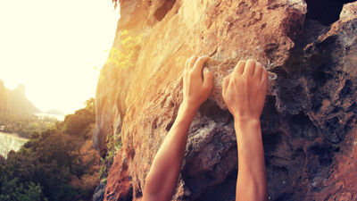 young woman rock climber hands climbing at seaside mountain cliff rock