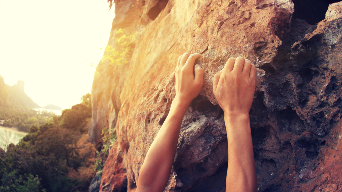young woman rock climber hands climbing at seaside mountain cliff rock