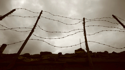 barbed wire fence and wall