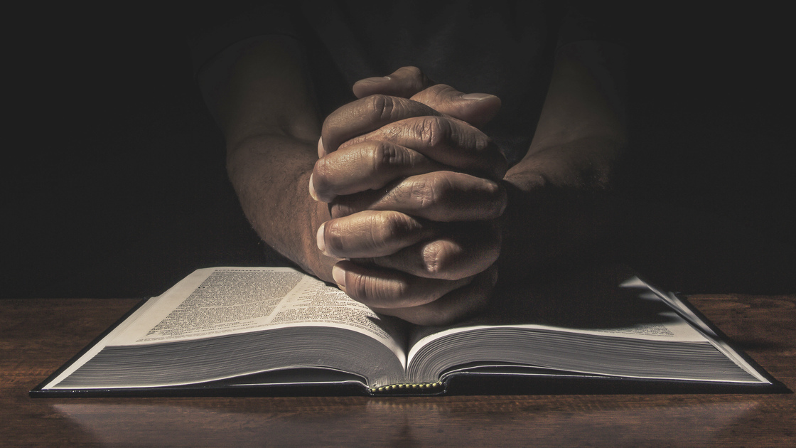 Men praying in the dark.