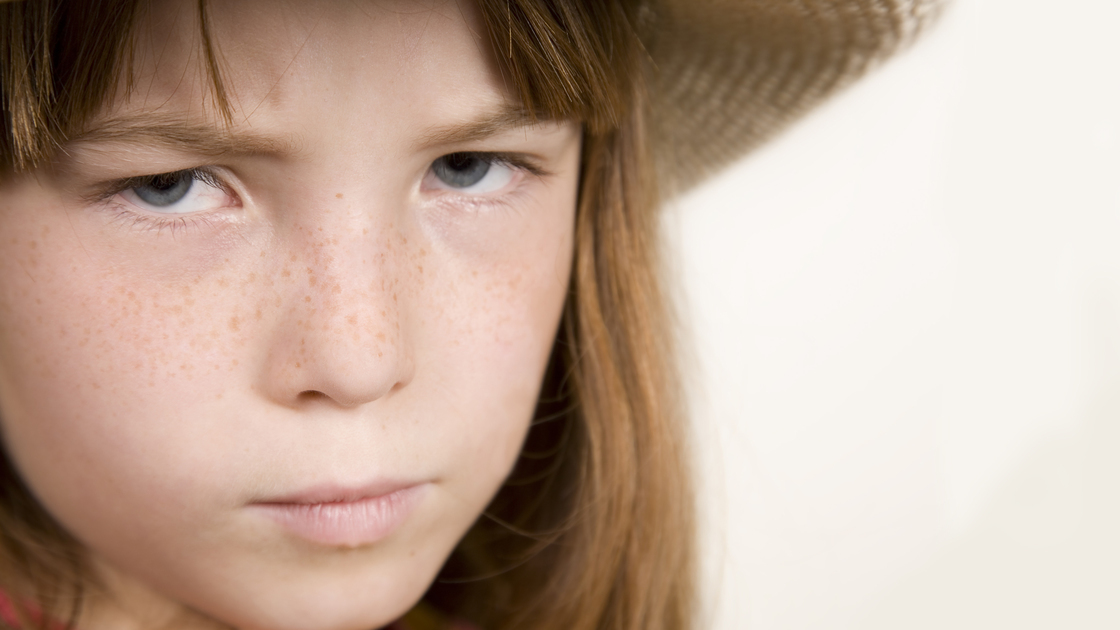 Upset Young Girl With Hat On.