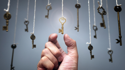 Choosing the key to success from hanging keys concept for aspirations, achievement and incentive