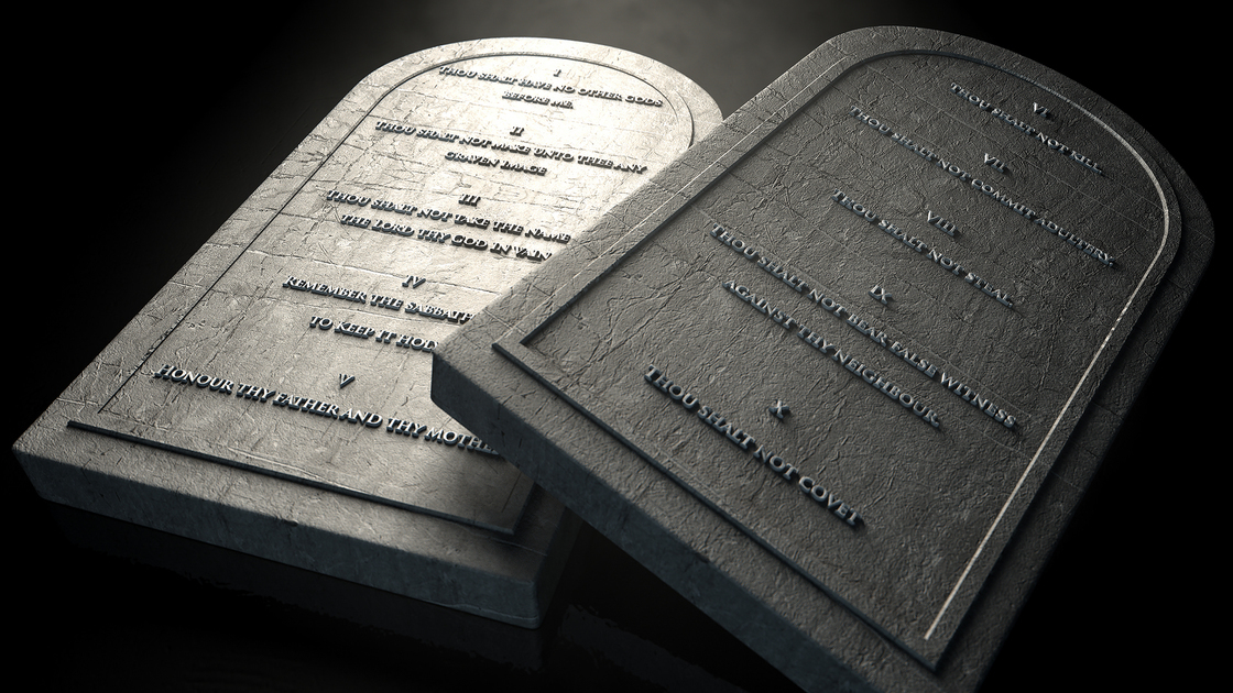 Two representative stone tablets with the ten commandments inscribed on them on an isolated dark ethereal background