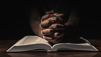 Men praying in the dark.