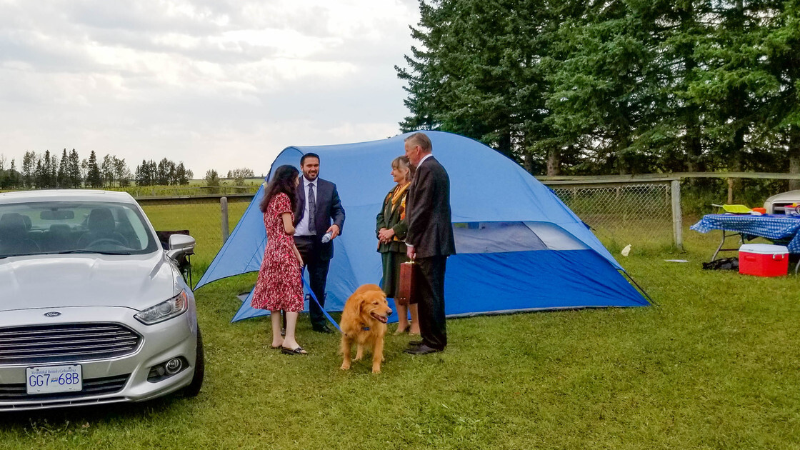ACT CAN brethren fellowshipping outside of tent on the Sabbath