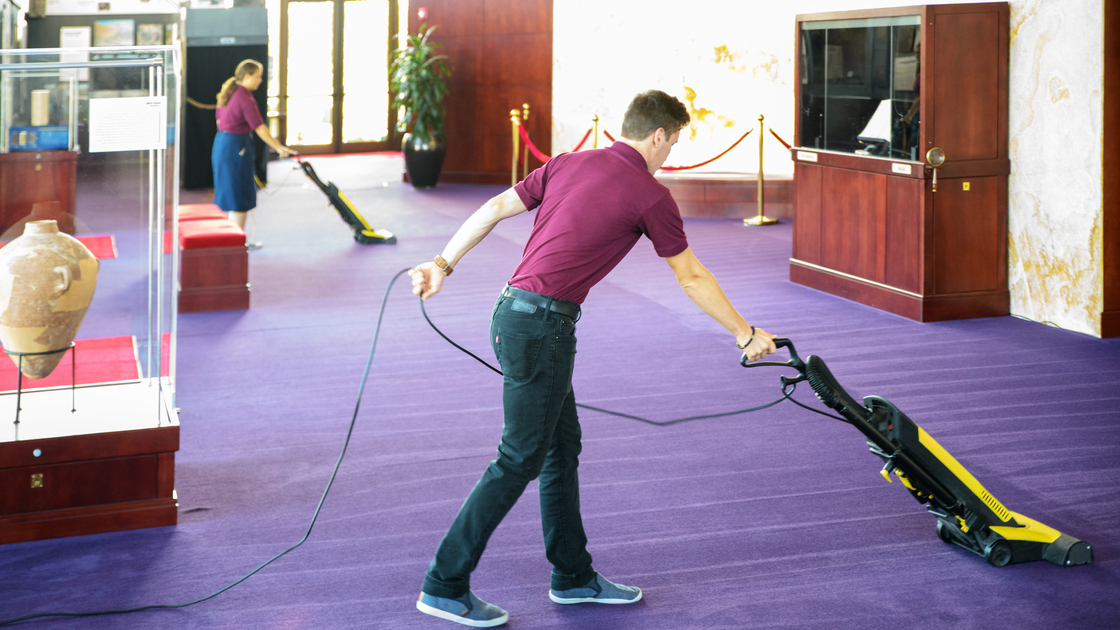 DEPT Custodial Zechariah Henderson and Kathleen Hochstetler vacuuming grand lobby carpet with patterns 16x9