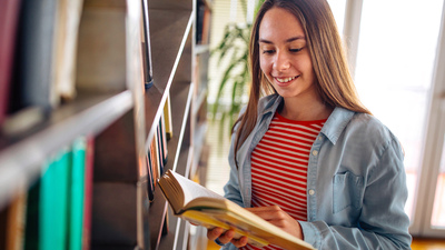 Photo of girl reading she favorite book at home