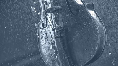 Violin being showered in rain, shot in black and white. 