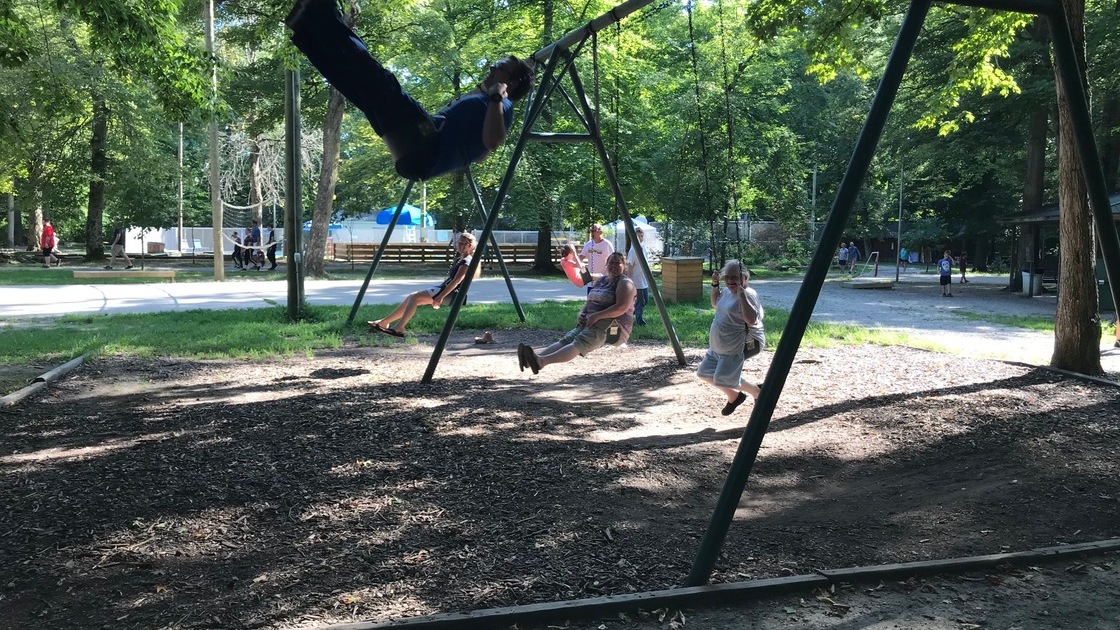 ACT Northeast campout brethren swinging and smiling on campground 