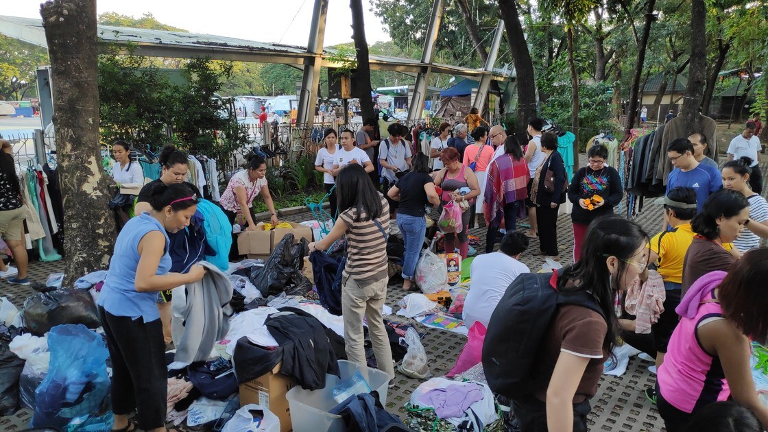 ACT Philippines Rummage Sale, guests looking through clothing items