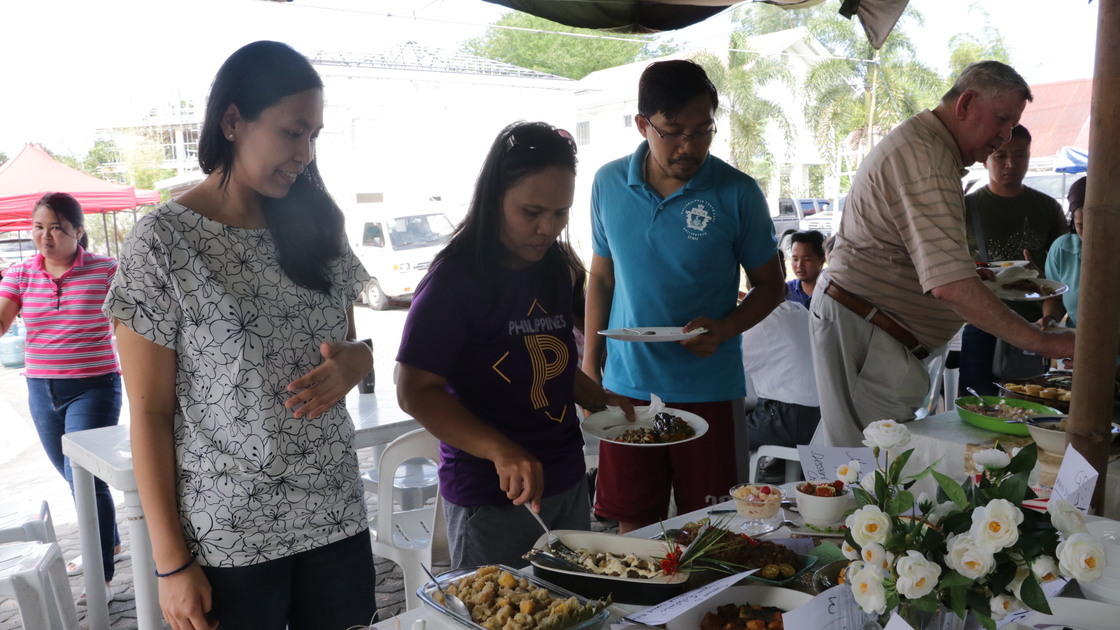 ACT Philippines cookfest, singles going through line to eat food prepared in the competition