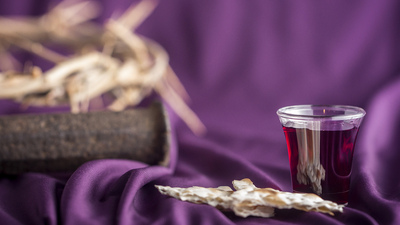 Commuion and Symbols of the Crusifixion on a Purple Cloth