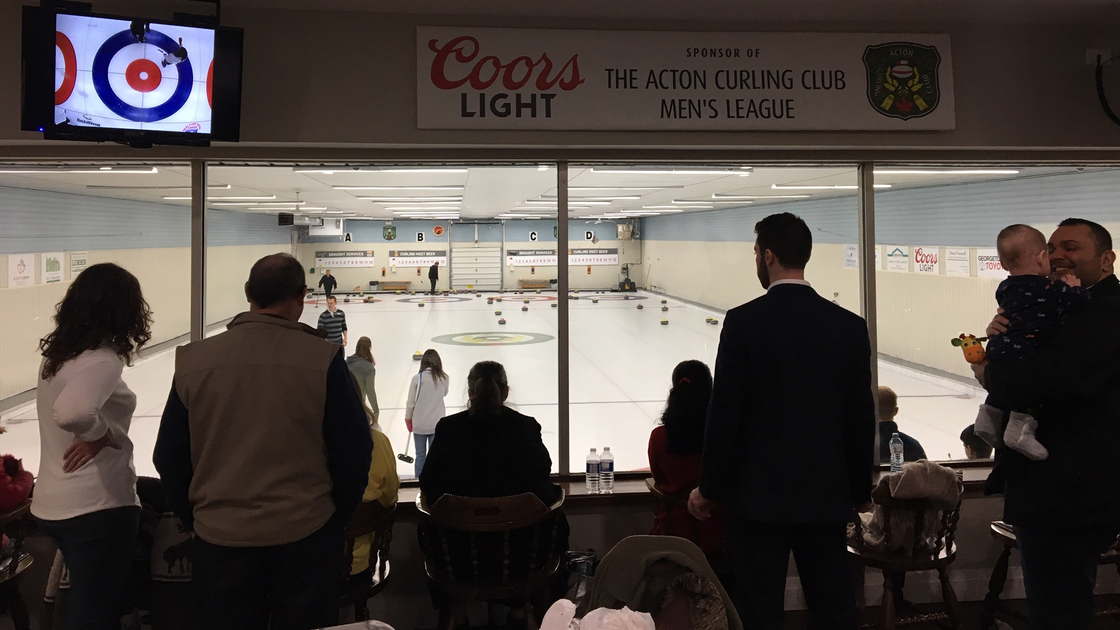 Canada activity curling, members on ice, watching from above view 16x9