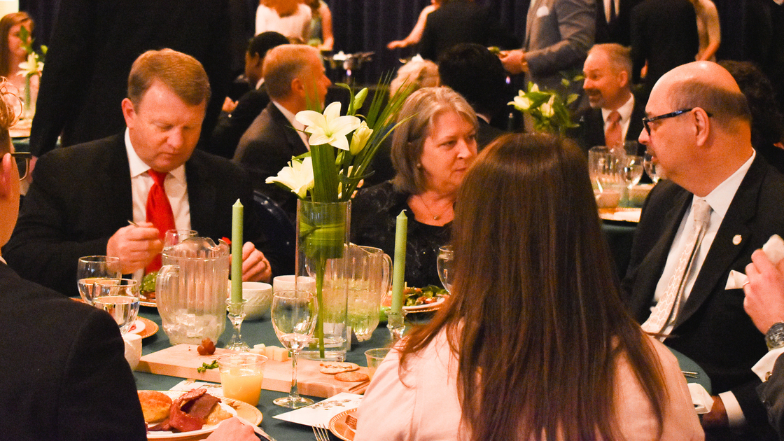 ACT Speech Banquet 2019, students and faculty conversing at table, 16x9