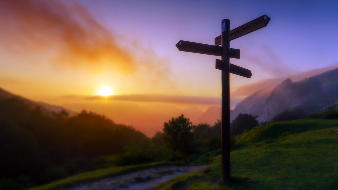 signpost in the mountain at the sunset