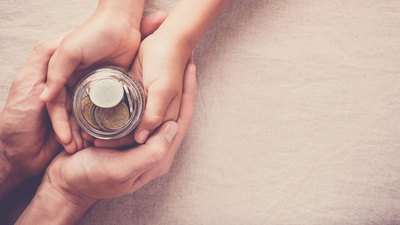 child and adult holding money jar, donation, saving concept