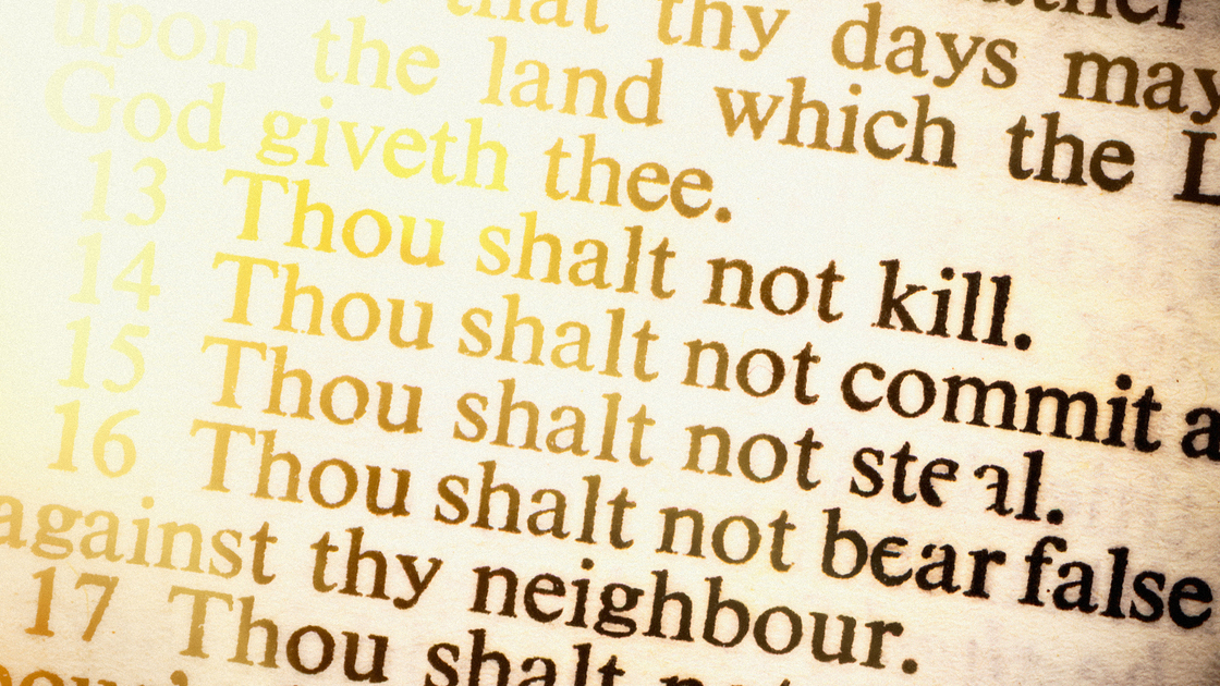 Close up on part of the Ten Commandments as seen in an old copy of the Holy Bible.