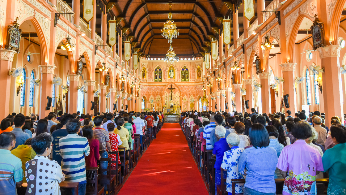 Chantaburi, Thailand - January 1, 2016: Group of pastors doing religion ceremony while Chistian people standing to attend religion ceremony in occasion of new year festival in beautiful church in Chantaburi, Thailand