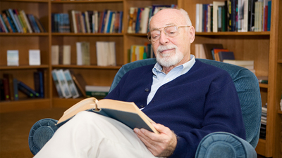 Handsome senior man relaxing with a good book.  Plenty of room for text.