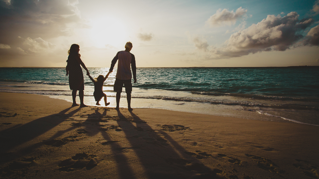 happy family with two kids on play on sunset tropical beach