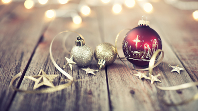 Christmas holiday nativity bauble and rustic decorations on an old wood background with defocused lights