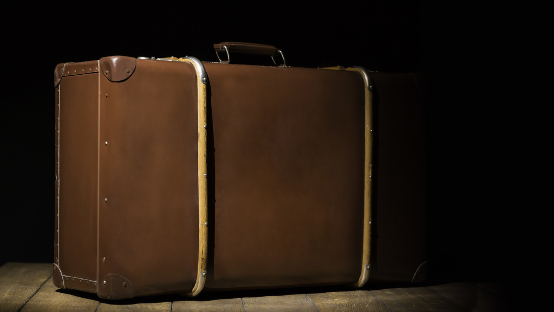 old vintage suitcase on wooden floor