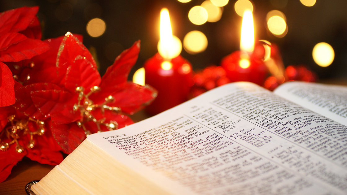 Open Bible with Christmas story and Christmas decorations. Selective focus, shallow DOF.