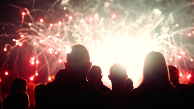 Crowd watching fireworks and celebrating at night