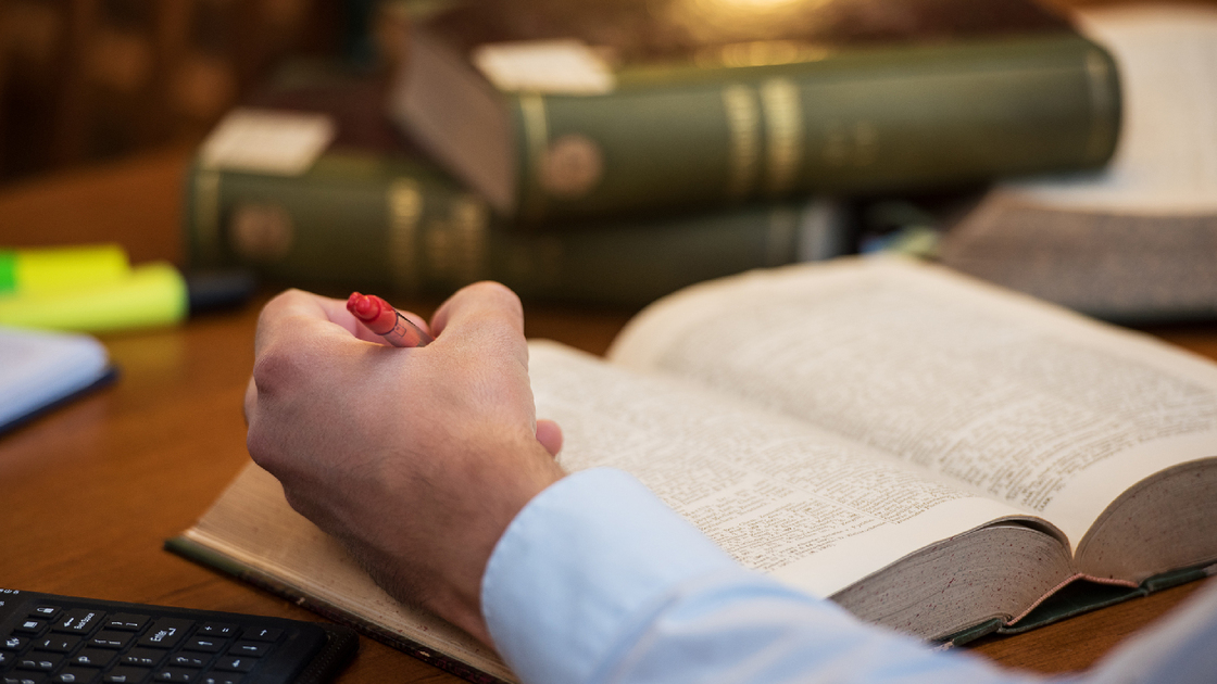 View of a man hand on the book in public library.