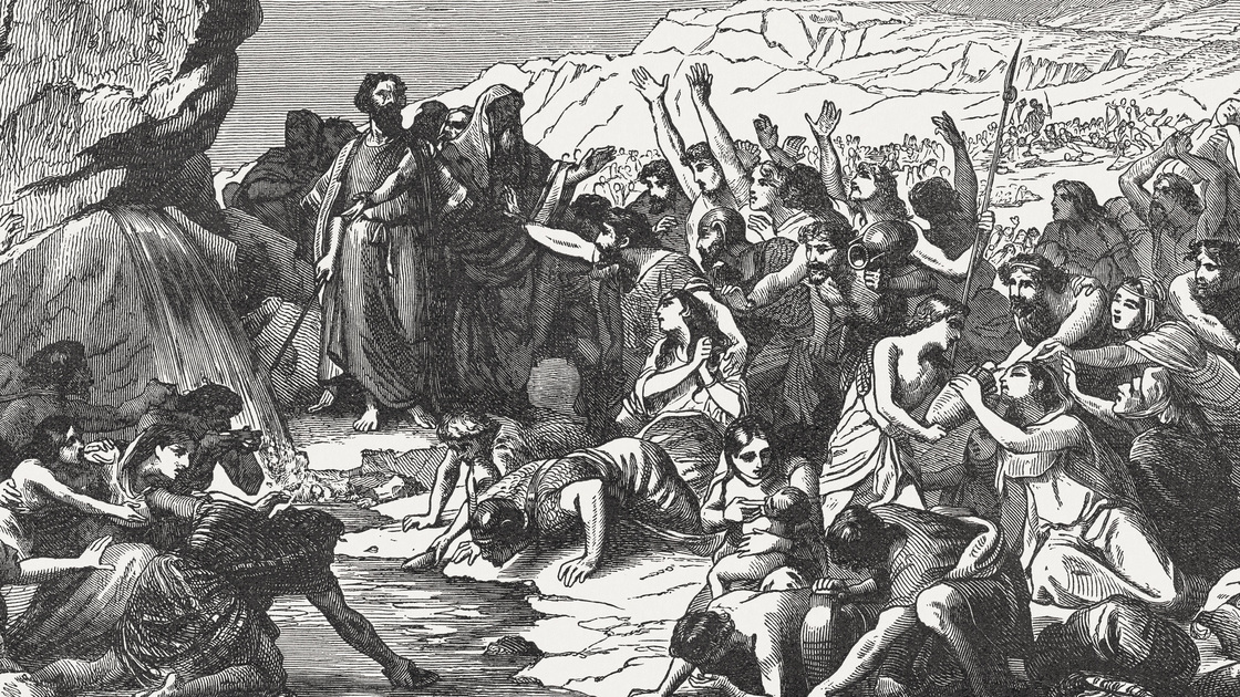 Moses strikes the rock at Horeb and makes water come out to quench the thirst of the Israelites (Exodus 17). Wood engraving, published in 1886.