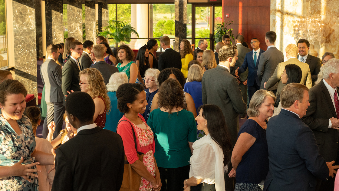 Brethren fellowshipping at Armstrong Auditorium lobby.