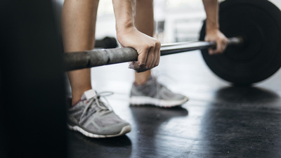 Woman lifting weights in gym