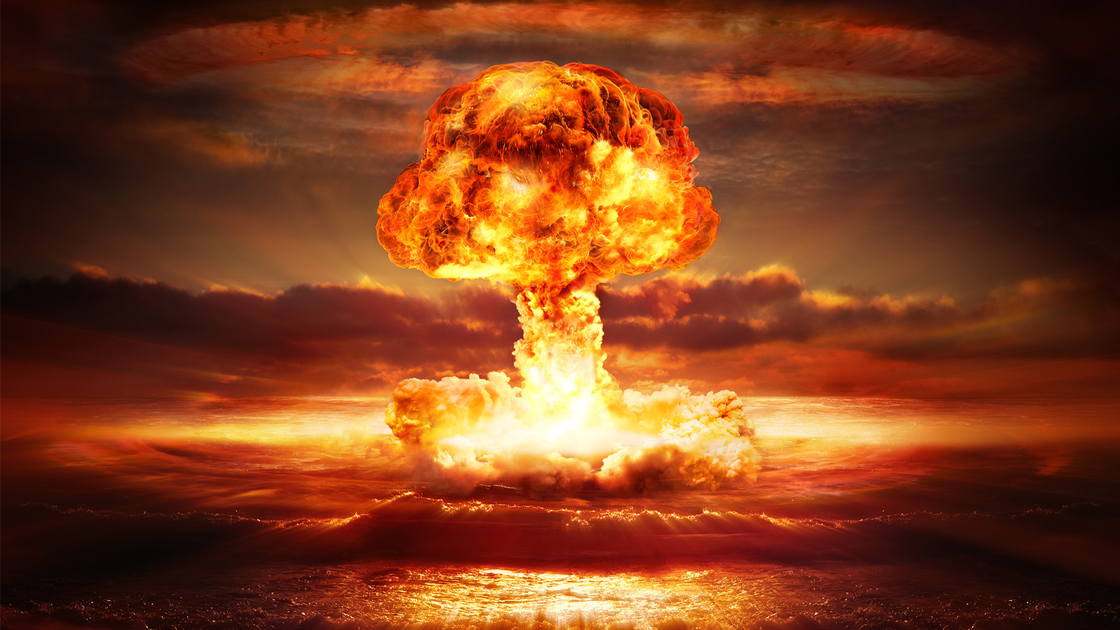 testing of atomic bomb over ocean with mushroom clouds - red destroy