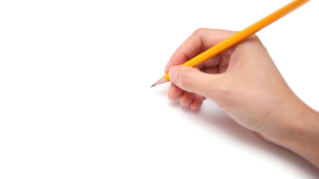 A hand is holding a pencil ready to draw, isolated on white background.