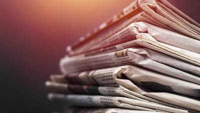 Pile of newspapers on white background