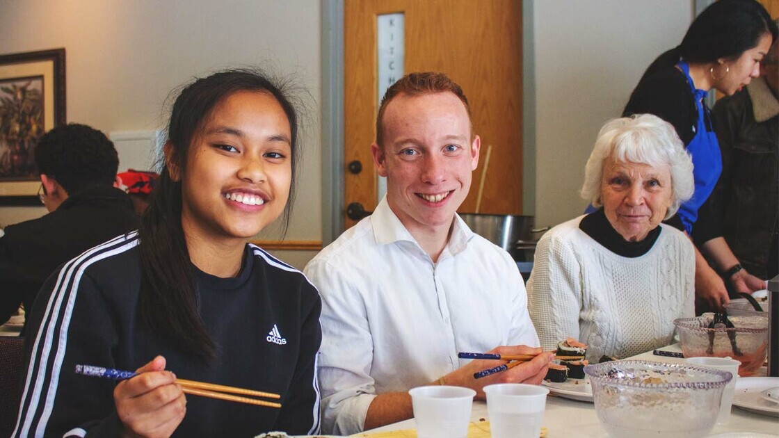 Singles Jenna Natanawan, Parker Campbell, and Ms. Fleetwood at SWW 2021 making sushi.