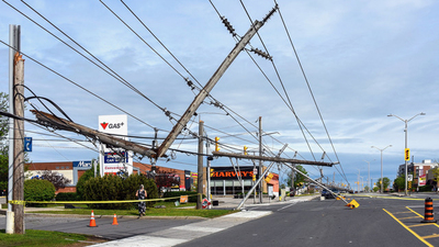Ottawa, Canada - May 22, 2022:  Power lines and traffic lights down on Merivale Road, a busy street in the west end of Ottawa after a severe storm (derecho) passed through the area causing a lot of damage and power outages the day before.