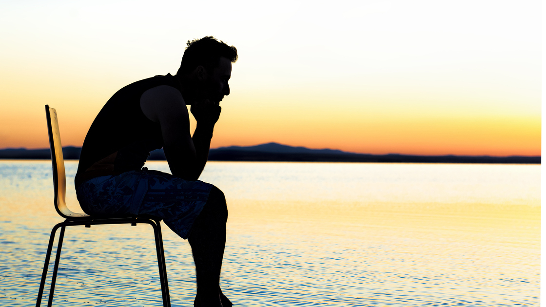 Young man relaxing at sunset