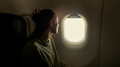 Young woman enjoying the aerial view from her window seat