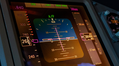 Primary Flight Display on a large modern jet aircraft. Display show Artificial Horizon, Airspeed, Altitude and Heading. Also show are the engaged autothrottle and navigation modes (lateral and vertical)