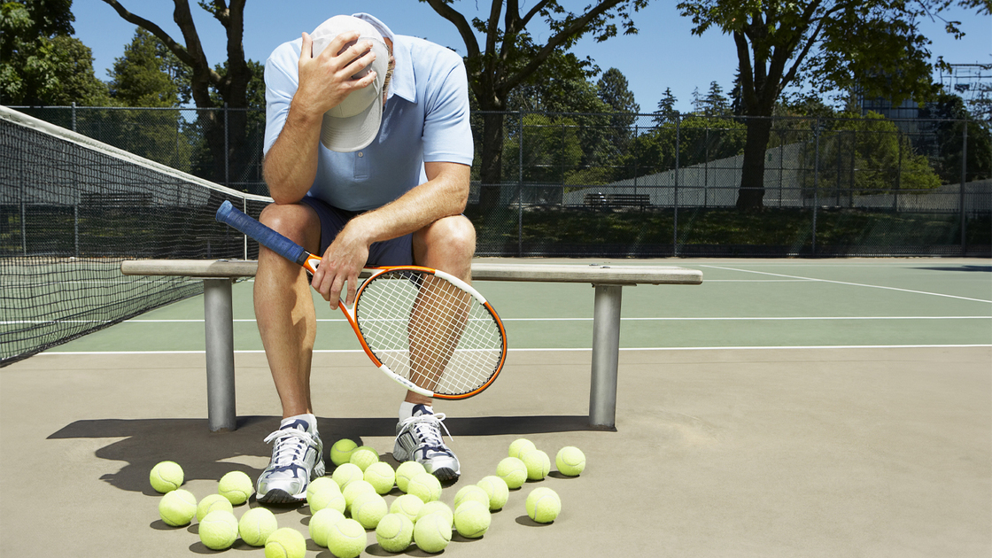 Tennis player with his head in his hands