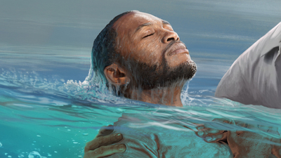 African American man coming up from immersion baptism