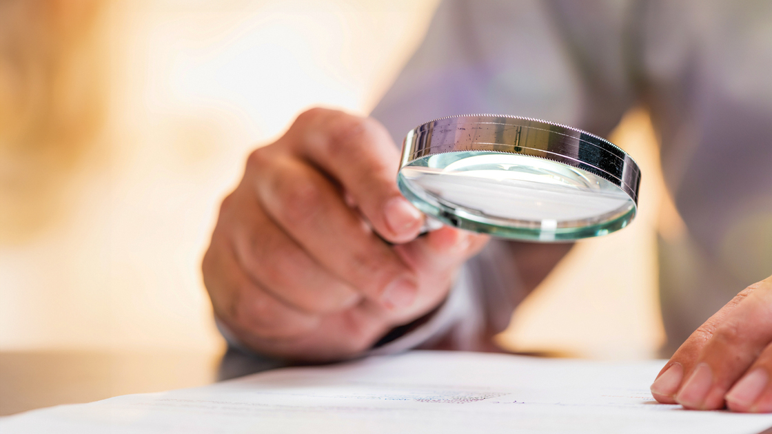 Businessman Reading Contract Details Before Signing